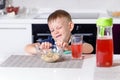 Young Boy Pushing Away Bowl of Breakfast Cereal