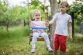 Young boy pushing toddler sister on swing Royalty Free Stock Photo