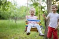 Young boy pushing toddler sister on swing Royalty Free Stock Photo