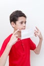 Young boy putting on a face mask to stop spread of germs