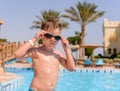 Young boy putting on his swimming goggles Royalty Free Stock Photo