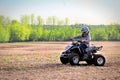 A young boy quading in a spring field Royalty Free Stock Photo