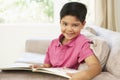 Young Boy Reading Book At Home Royalty Free Stock Photo