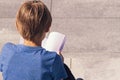 Young boy reading book outdoors Royalty Free Stock Photo