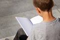 Young boy reading book outdoors Royalty Free Stock Photo
