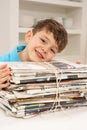 Young Boy Recyling Newspapers At Home