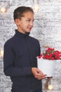 Young boy with red flowers Royalty Free Stock Photo