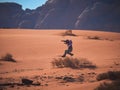 Young boy on the red sand dunes of the Wadi Rum desert, Jordan Royalty Free Stock Photo