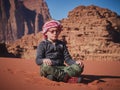 Young boy on the red sand dunes of the Wadi Rum desert, Jordan Royalty Free Stock Photo