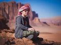Young boy on the red sand dunes of the Wadi Rum desert, Jordan Royalty Free Stock Photo