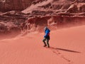 Young boy on the red sand dunes of the Wadi Rum desert, Jordan Royalty Free Stock Photo