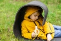 A young boy rests lying on a tourist mat in the woods and eats a banana Royalty Free Stock Photo