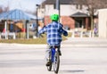 Young boy riding his bike to the community park in afternoon Royalty Free Stock Photo