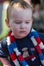 Young boy riding in red wagon having fun in the park for July Fourth Royalty Free Stock Photo