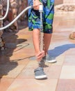 Young boy rinsing off his feet and shoes