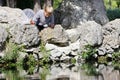 Young boy on rocks and looking into water Royalty Free Stock Photo