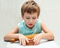 Young boy rolling gingerbread dough