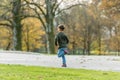 Young boy running in autumn park Royalty Free Stock Photo