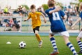 Young Boy Running Fast and Kicking Soccer Ball on Grass Pitch Royalty Free Stock Photo