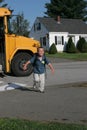 Young boy running off the school bus smiling Royalty Free Stock Photo
