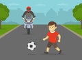 Young boy running onto road directly in front of moto rider. Kid playing football on the street.