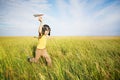 Young boy running with paper airplane.