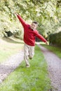 Young boy running on a path outdoors smiling Royalty Free Stock Photo