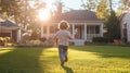 A young boy runs towards the setting sun in a suburban yard Royalty Free Stock Photo