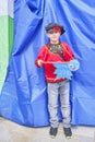 Young boy in Russian national clothes. Peddler of small items on traditional Irbit fair, Russia.