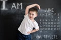 Young boy`s doing athletic exersices near blackboard. Young athlete. Creative design concept for 2019 calendar. June