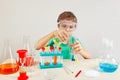 Young boy in safety goggles doing chemical experiments in laboratory Royalty Free Stock Photo