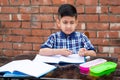 Young boy sharpening the pencil in classroom while attending class in primary School