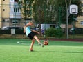 Young boy shoots the ball to goal