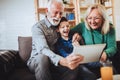 Boy showing his older grandparents new technology Royalty Free Stock Photo