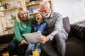 Boy showing his older grandparents new technology Royalty Free Stock Photo