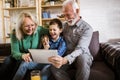 Boy showing his older grandparents new technology Royalty Free Stock Photo