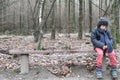 Young boy sitting alone on a rustic bench Royalty Free Stock Photo