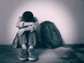 Young boy sitting alone and sad at the school.