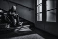 A young boy sitting alone on a stairs