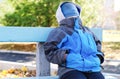 Young boy sitting on a bench with his face covered Royalty Free Stock Photo