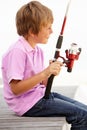 Young boy sitting with fishing rod Royalty Free Stock Photo