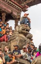 Young boy sitting on lion sculpture