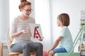 Friendly speech therapist and boy Royalty Free Stock Photo