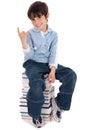 Young boy sitting over tower of books Royalty Free Stock Photo