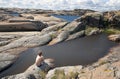 Young boy sitting at the rock and looking on sea. Royalty Free Stock Photo