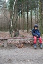 Young boy sitting on a rustic wooden bench Royalty Free Stock Photo