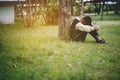 Young boy sitting sadly alone in the forest Depression concept Royalty Free Stock Photo