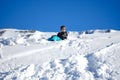 Young Boy Sitting On The Snow Mountain Royalty Free Stock Photo