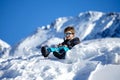 Young Boy Sitting On The Snow Mountain Royalty Free Stock Photo