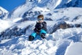 Young Boy Sitting On The Snow Mountain Royalty Free Stock Photo